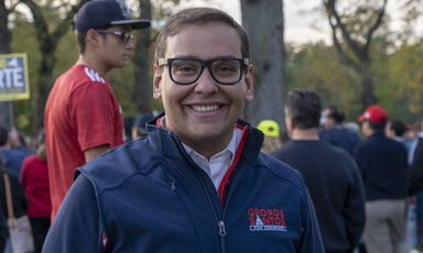 Man stands with people behind him