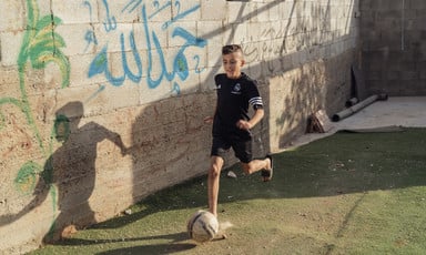 Ahmad Dawabsheh runs with a football at his feet