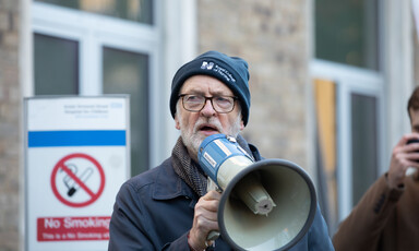 Man wearing hat holds megaphone