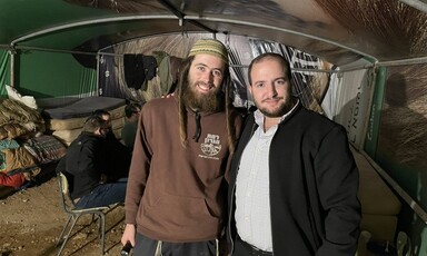 Elisha Yered and Yossi Levi stand inside a structure