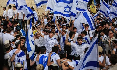 Young men wave Israeli flags