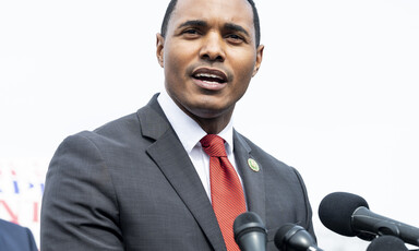 Congressman Ritchie Torres stands with microphones in front of him