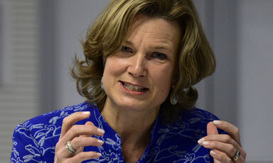 Shot of a woman from shoulders up gesticulating and speaking