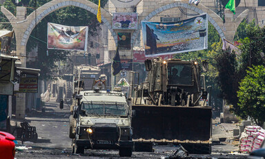 An Israeli military bulldozer and jeep in Jenin refugee camp