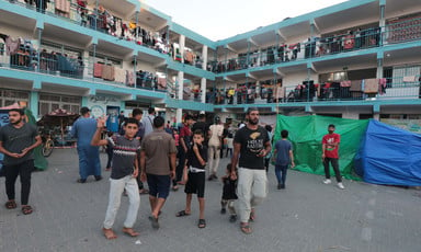 A number of people stand in the yard of a crowded school in southern Gaza 
