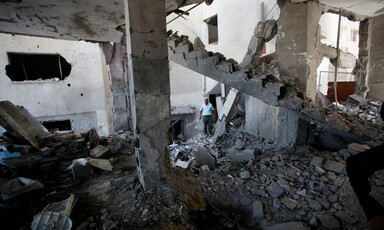 People inspect extensive damage and debris following airstrike 