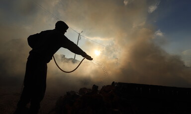 Silhouette of a man against a backdrop of smoke 