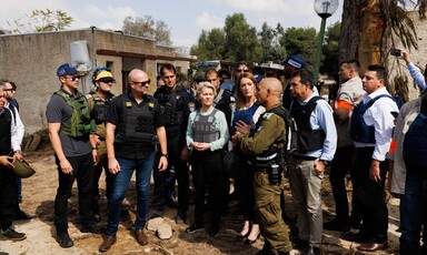 European Commission President Ursula von der Leyen wears a flak jackets while she talks to representatives of Israel's military 