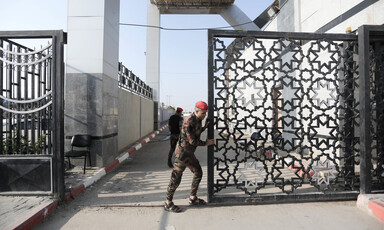 A soldier opens the gate of the Rafah crossing in southern Gaza.
