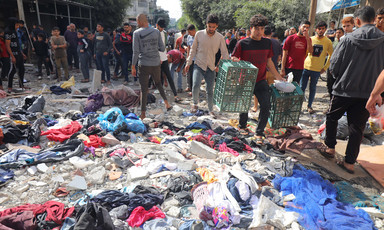 Young men beside various items strewn on the ground following an Israeli airstrike in Gaza. 