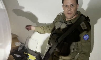 Screenshot of Israeli military spokesperson gesturing to pile behind an MRI machine