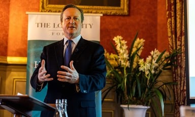 The former British prime minister David Cameron uses his hands to emphasise a point while speaking at an event 