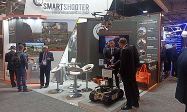 Men wearing suits at an exhibition stand for the Israeli company Smartshooter