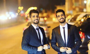 Twin brothers Khalid and Salah Jadallah wearing suits 