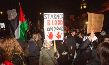 Woman with placard reading: Starmer blood on your hands