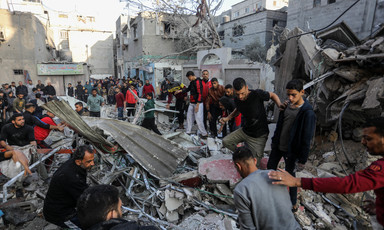 Men search in the remains of a family home following an Israeli airstrike in the southern Gaza city of Rafah 
