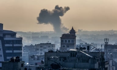 Smoke from an explosion rises above residential buildings in the southern Gaza city of Rafah 