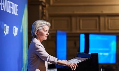 Ursula von der Leyen from the European Commission stands at the podium during a conference about supporting the weapons industry 