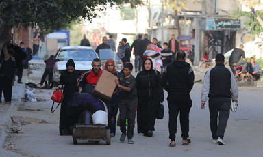 A family carry their belongings after they have been ordered to leave their home in Gaza 