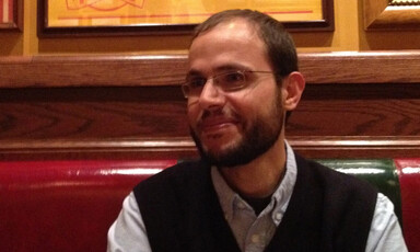 A close-up of Dr. Refaat Alareer, smiling