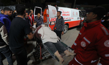 Medics tend to an injured man beside an ambulance in Gaza 