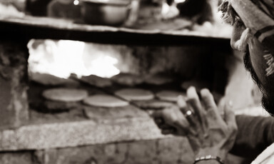 Bread is prepared in a makeshift oven.