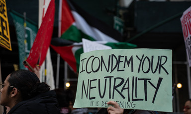 A protest sign reads: I condemn you neutrality