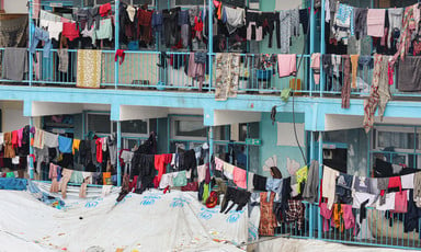 Tents and washing lines compete for space in a school