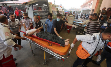 Paramedics bring an injured man to hospital