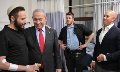 Benjamin Netanyahu and Brian Mast meet with an injured Israeli soldier at a hospital as an additional person looks on