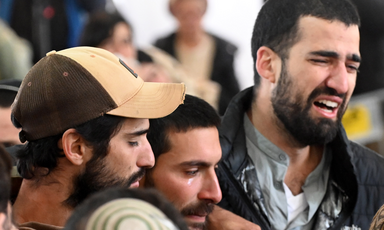 Close up of faces of three anguished young men