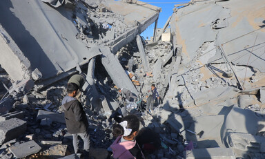 Children among the remains of a school that Israel has destroyed in Gaza 