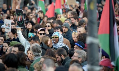 Crowds demonstrate with the Palestinian flag