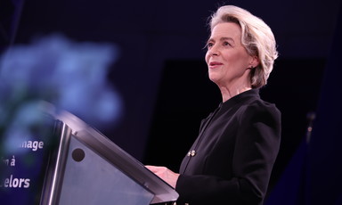 European Commission President Ursula von der Leyen stands at a podium 