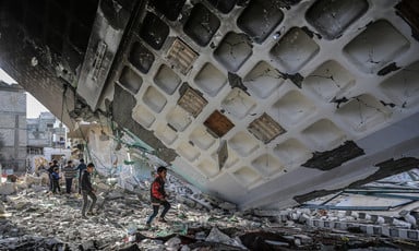 children walk in rubble