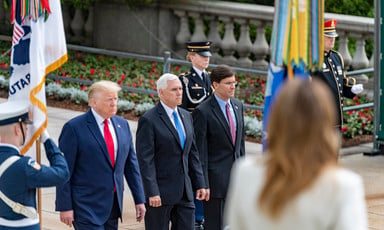 Secretary of Defense Mark Esper walks alongside Vice President Mike Pence and President Donald Trump with military personnel present at Arlington National Cemetery