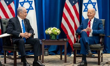 Benjamin Netanyahu and Joe Biden, seated, with US and Israeli flags behind them