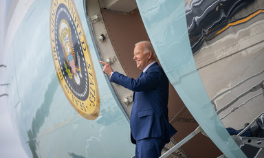 US President Joe Biden stands and waves at the door of Air Force One 