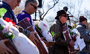 People hold imitation children's coffins