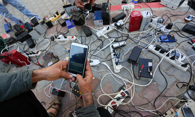 A bunch of phones being charged on a mobile battery