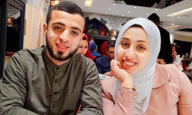 Brother and sister Abdul Rahman and Malak Mansor sit beside each other in a cafe