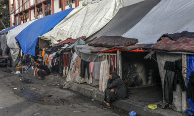 A man sits outside a row of makeshift tents in the southern Gaza city of Rafah 
