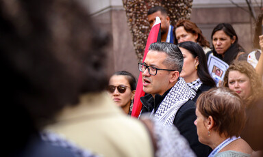 A man speaks in a crowd of people