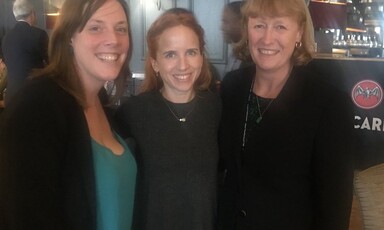 Three women pose for the camera