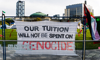 A sing reads: Our tuition will be spent on genocide 