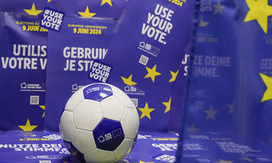 A football beside posters saying Use Your Vote in a number of languages 