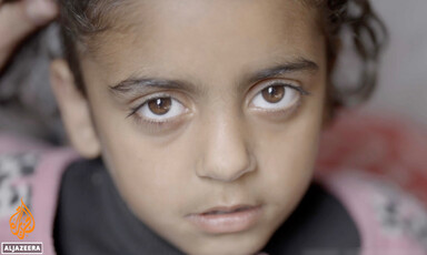 A Palestinian child looks into the camera