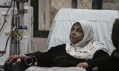 A woman receives treatment in a hospital bed