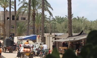 People leaving homes hurriedly in cars and on a bicycle 