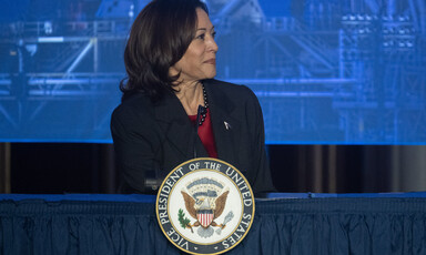 Kamala Harris stands at podium with vice presidential seal on it